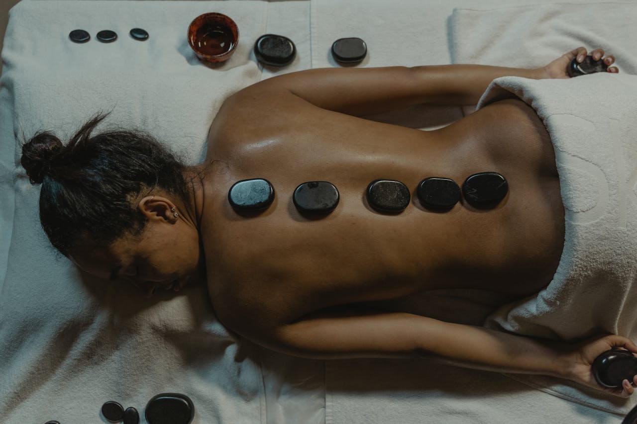 A serene spa scene with hot stone massage therapy focusing on health and relaxation.